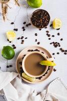 A cup of latte infused with lime on the table top and vertical view photo