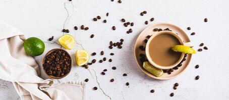 A cup of latte infused with lime on the table top view web banner photo