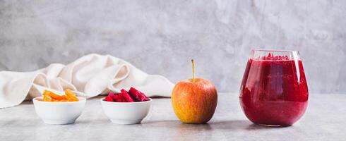 ABC juice from beetroot, carrot and apple for detox in a glass on the table web banner photo