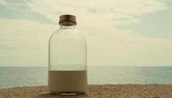 A bottle of milk sitting on the beach photo