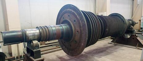 Industrial medium pressure turbine rotor in a workshop. Mechanical engineering. Power engineering. photo
