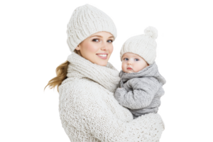 A mother and baby warmly dressed in matching knitwear, including hats and sweaters, create cozy and affectionate scene. neutral colors add soft, comforting feel png