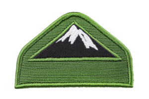 A green embroidered patch features stylized mountain design with white peaks, set against transparency background. patch is triangular with green border, symbolizing adventure and nature png