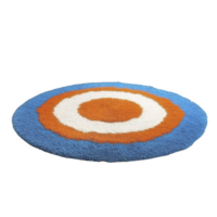 A round, colorful rug with concentric circles in blue, orange, and white, creating vibrant and modern design. shaggy texture adds cozy feel, perfect for contemporary interiors png