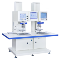 This shows dual station industrial machine with two workstations, each equipped with control panel and display screens. machine is designed for precision tasks manufacturing environments png