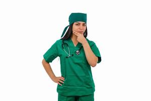 Confident latin surgeon posing with hand on chin and white background photo