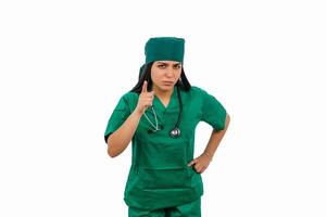 Female surgeon pointing with finger and wearing green scrubs and stethoscope photo