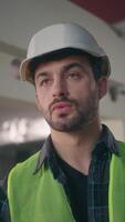 Caucasian man architect contractor guy male executive technician talking walkie talkie connect builder communicate radio set in construction foreman control work employee building process manufactory video