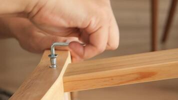 Assembly of wooden chair using hand tools in modern workspace video