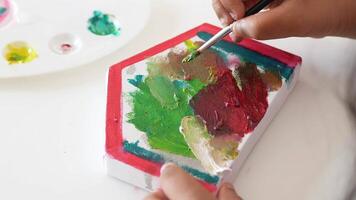Creating colorful art with paint on canvas at creative studio video
