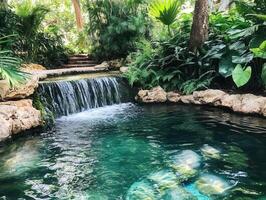 A serene waterfall cascading into a tranquil pool surrounded by lush greenery. photo