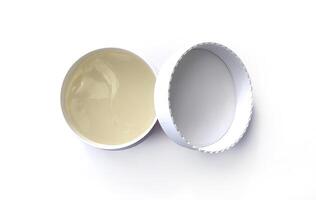 Under eye patches in open jar with lid isolated on white background, top view. Cosmetic product photo