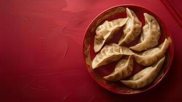 Traditional Asian dumplings wontons on a red background with copy space for text. Minimalistic Background for cafes and restaurants of Asian cuisine photo