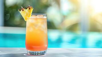 tropical cocktail in a glass with ice cubes, a slice of fresh pineapple on a bar counter near a swimming pool at a tropical summer resort photo