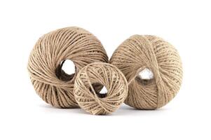 Three balls of twine in varying sizes against a clean white background, ideal for crafting. photo