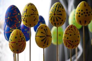 Decorative Easter eggs with colorful patterns are arranged on display for the spring holiday season. photo
