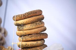 A stack of delicious bublik pastries, adorned with poppy seeds, are tied with rustic string. photo