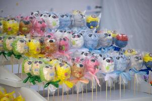 A colorful array of animal-shaped lollipops creates a delightful and whimsical sweet treat display. photo