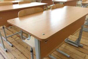 Classroom Desks Arranged in Rows Under Bright Natural Light With Metal Legs photo