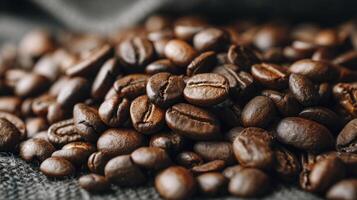 Roasted Coffee Beans Close-up Displayed on Textured Gray Fabric Background photo