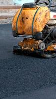 Compaction of asphalt with a road vibroplate. Ramming with your own hands sidewalks near residential buildings. video
