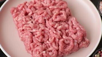 Stuffing or ground beef or pork with salt and spices on a black background video