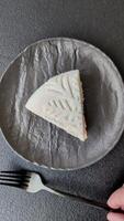 Piece of cheesecake. Nuts and berries with winter pattern on dark concrete background video
