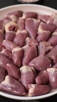 Chicken raw heart, red duck internal organs as an ingredient for dinner preparation video