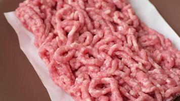 Stuffing beef or pork with salt and spices on a black background video