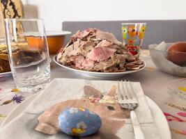 Easter brunch table setting with ham and colorful decor photo