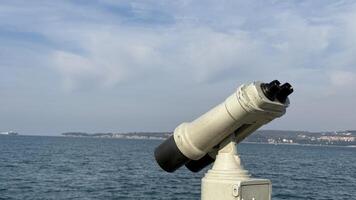 Seaside binoculars overlooking tranquil ocean, perfect for coastal exploration, summer vacation, maritime adventures, horizon view travel inspiration photo