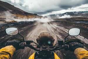 A rider grips motorcycle handlebars while navigating a dusty road surrounded by volcanic features and dramatic mountains. Dark clouds loom overhead, suggesting an adventure filled with excitement. photo