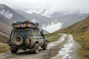 An off-road vehicle is parked on a winding dirt road surrounded by majestic mountains. Colorful flags adorn the roof, hinting at a journey through wild landscapes. photo