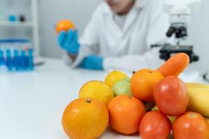 Scientist check chemical food residues in laboratory. Control experts inspect quality of fruits, vegetables. lab, hazards, ROHs, find prohibited substances, contaminate, Microscope, Microbiologis photo