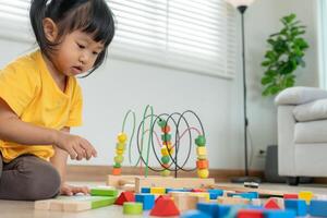 Happy children play and learn toy blocks.family is happy and excited in the house. daughter having fun spending time, Activity, development, IQ, EQ, meditation, brain, muscles, essential skills. photo