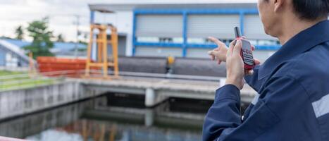 maintenance and inspector, Maintenance engineers are using walky talky to inform the results of inspection of buildings and structures. Irrigation engineers are exploring sluice systems photo
