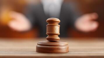 Gavel on Wooden Base Focused with Blurred Background of Person Engaging in Legal Discussion and Debate photo