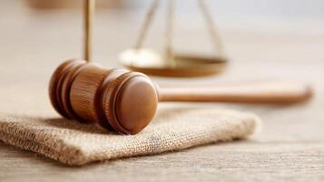 Wooden Gavel and Scales of Justice on Natural Burlap Cloth in Legal Setting photo
