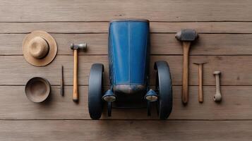 Vintage toy car with wooden tools and accessories on a rustic wooden background for creative designs photo