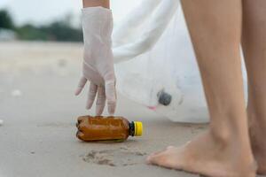 Save water. Volunteer pick up trash garbage at the beach and plastic bottles are difficult decompose prevent harm aquatic life. Earth, Environment, Greening planet, reduce global warming. photo