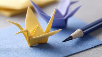 Colorful Paper Cranes and Drawing Tool on a Craft Surface for Creative Projects photo