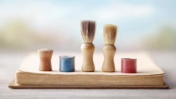 Wooden Brushes and Paint Sticks on Open Book Surface with Soft Background photo