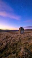 Majestic Monolith Glowing at Sunset Under Starry Sky in Serene Natural Landscape photo