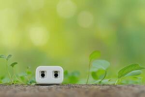 Single Unplugged Socket on Nature Background with Green Leaves Surrounding It photo