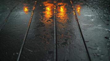 Reflective Water Surface on Wooden Planks Under Soft Orange Lighting in Rainy Weather photo