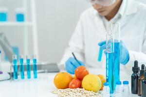 check chemical food residues in laboratory. Control experts inspect quality of vegetables vegetables. lab, hazards, find prohibited substances, contaminate, Microscope, Microbiologist photo