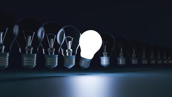 Idea concept and light bulb that illuminate on blue background. photo