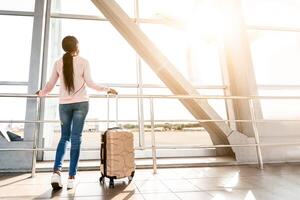 Waiting For Flight. Rear View Of Black Woman Looking At Window In Airport Terminal, Enjoying View, Ready For Trip, Free Space photo