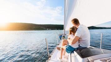 Back View Of Father And Daughter Sailing On Yacht Sitting Hugging On Sailboat Deck Enjoying Summer Vacation At Seaside. Family Boat Tour, Tourism Concept. Copy Space photo