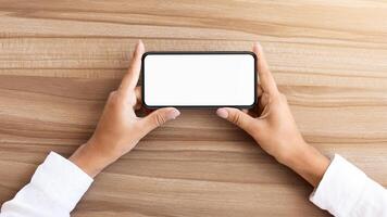 Girl watching or playing game on cell phone in horizontal position. Isolated screen for app mock up photo